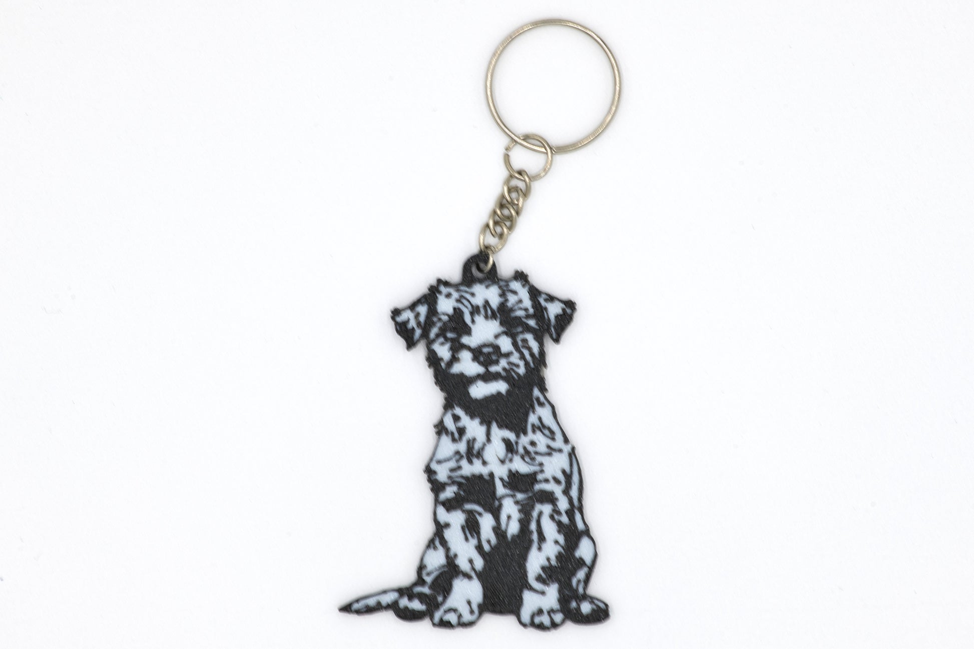 Keychain with a black and white Border Terrier silhouette dog design on a white background