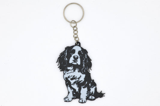Keychain with a black and white Cavalier King Charles Spaniel Silhouette dog illustration on a white background