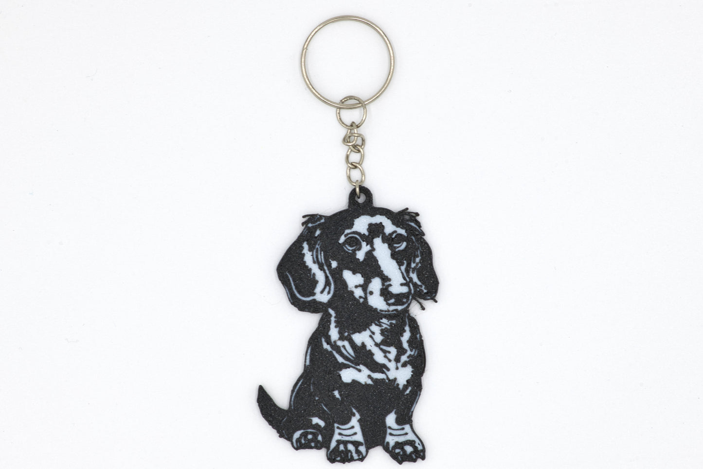 Keychain with a black dachshund design on a white background