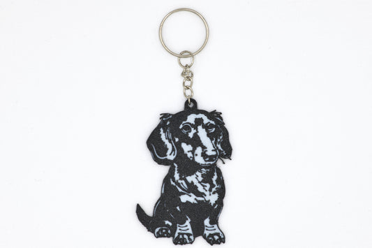 Keychain with a black dachshund design on a white background