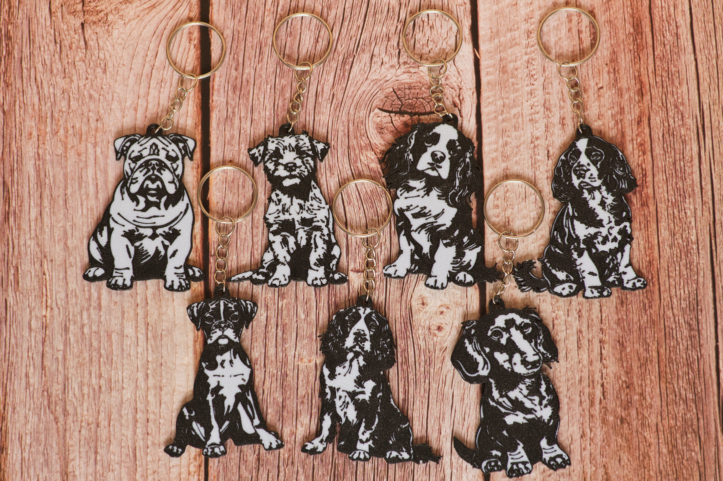 Set of dog-themed keychains on a wooden surface