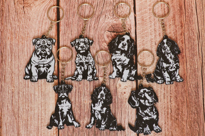 Set of dog-themed keychains on a wooden surface