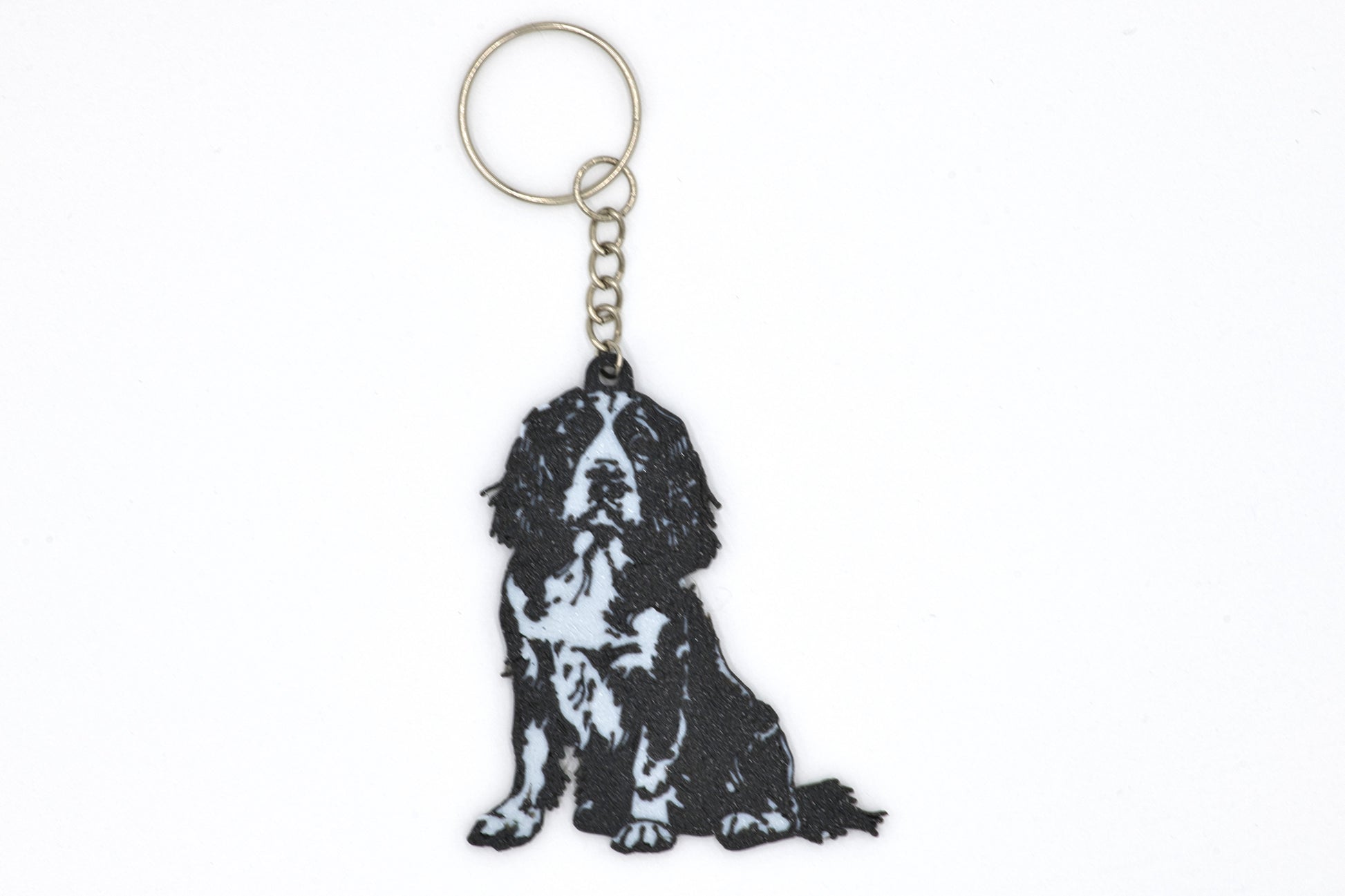 Keychain with a black and white English Springer Spaniel silhouette dog design on a white background