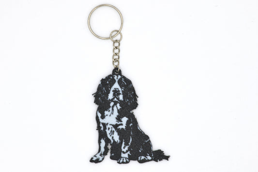 Keychain with a black and white English Springer Spaniel silhouette dog design on a white background