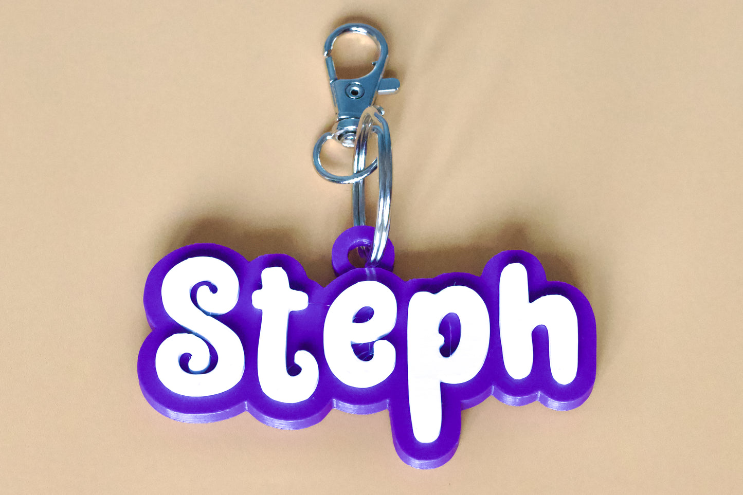 Keychain with 'Steph' in white letters on a purple background