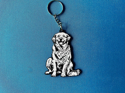 Golden Retriever Silhouette Keyring laying on a blue table cloth. The keyring features a white background with a black silhouette of a Golden Retriever.